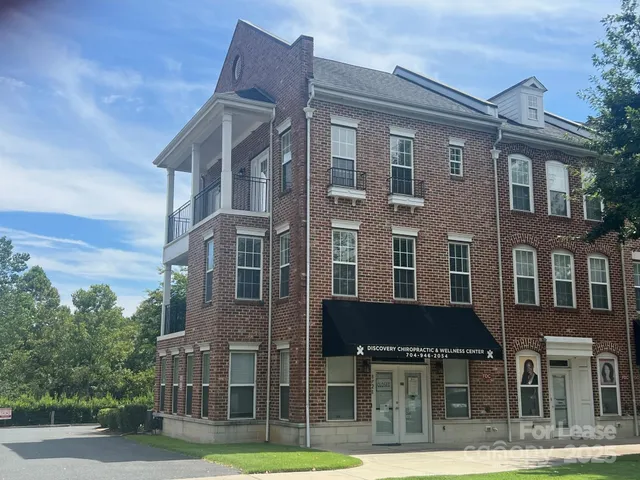 a front view of a residential apartment building with a yard