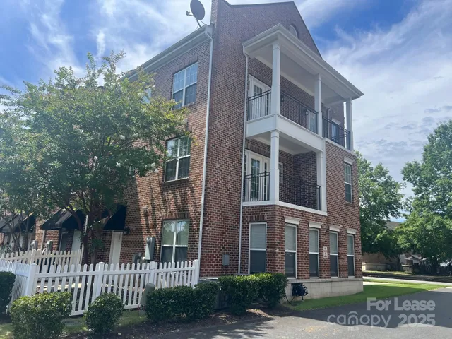 a view of a brick building next to a yard
