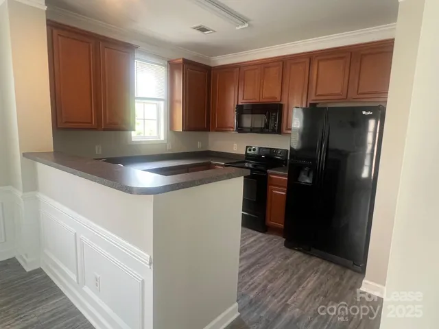 a kitchen with a refrigerator stove top oven and sink