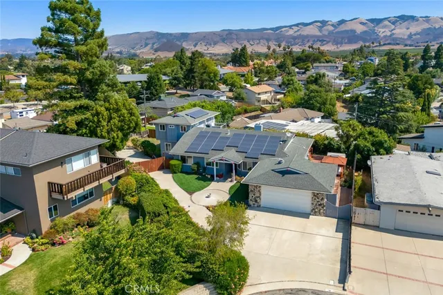 an aerial view of a house with a yard