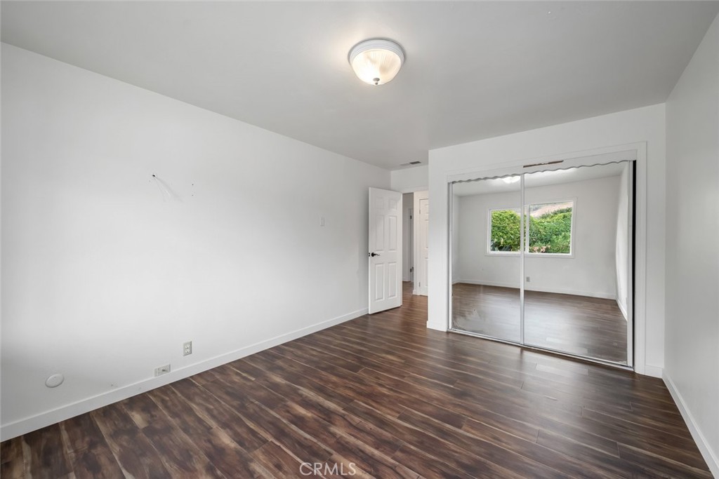 6001 Joan Place San Luis Obispo, CA 93401 - Photo 29 of 56 an empty room with wooden floor and windows