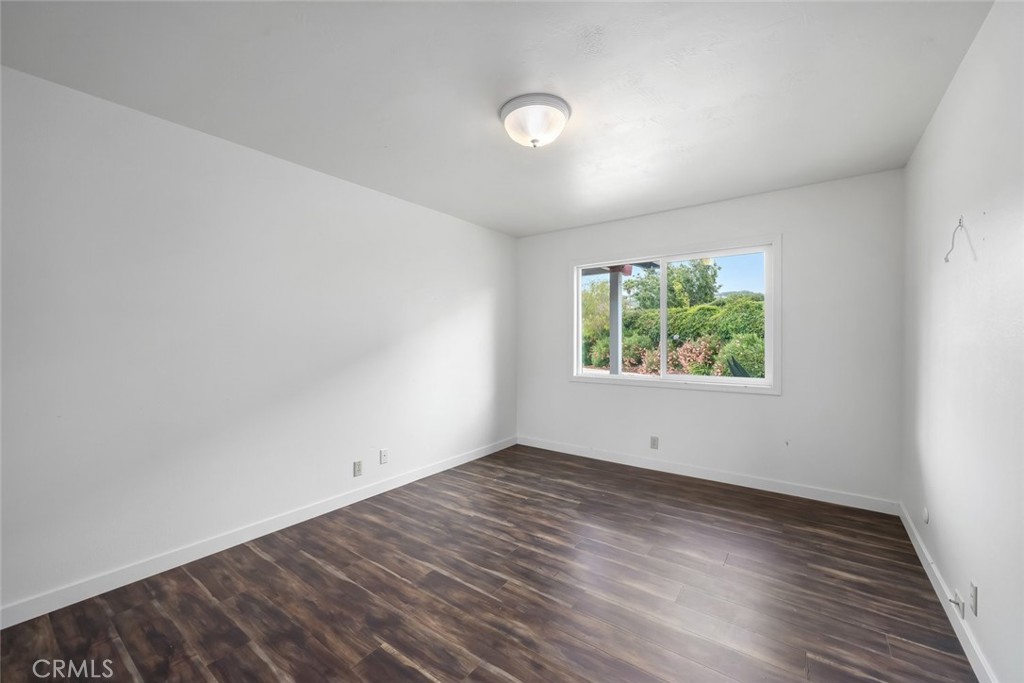 6001 Joan Place San Luis Obispo, CA 93401 - Photo 30 of 56 an empty room with wooden floor and windows