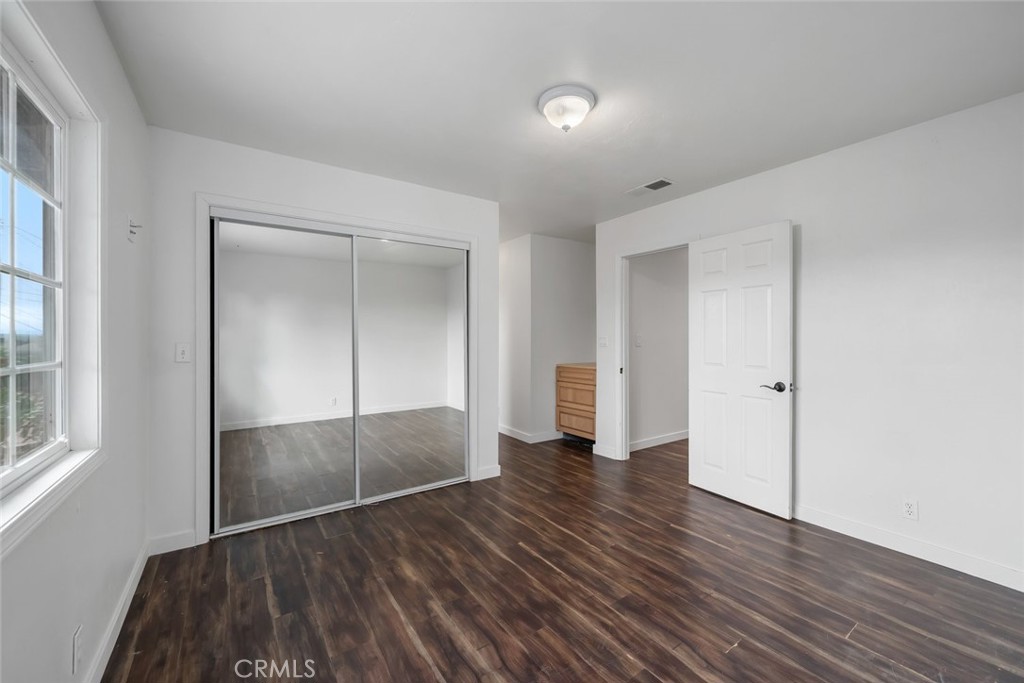 6001 Joan Place San Luis Obispo, CA 93401 - Photo 35 of 56 a view of empty room with wooden floor and fan