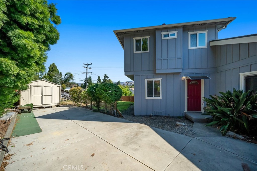 6001 Joan Place San Luis Obispo, CA 93401 - Photo 38 of 56 a front view of a house with a yard and garage