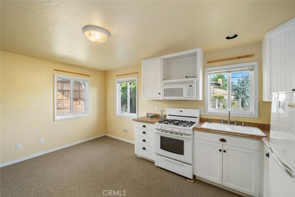 6001 Joan Place San Luis Obispo, CA 93401 - Photo 43 of 56 a white kitchen with a stove top oven