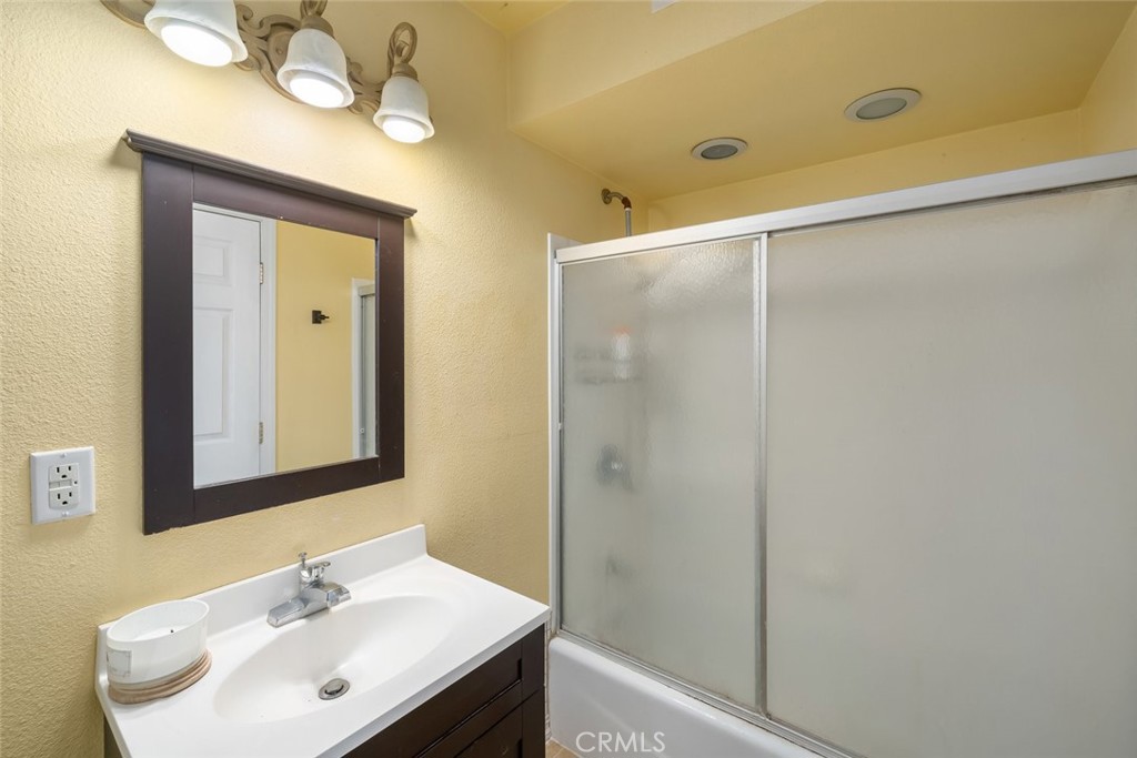 6001 Joan Place San Luis Obispo, CA 93401 - Photo 46 of 56 a bathroom with a sink mirror and a shower