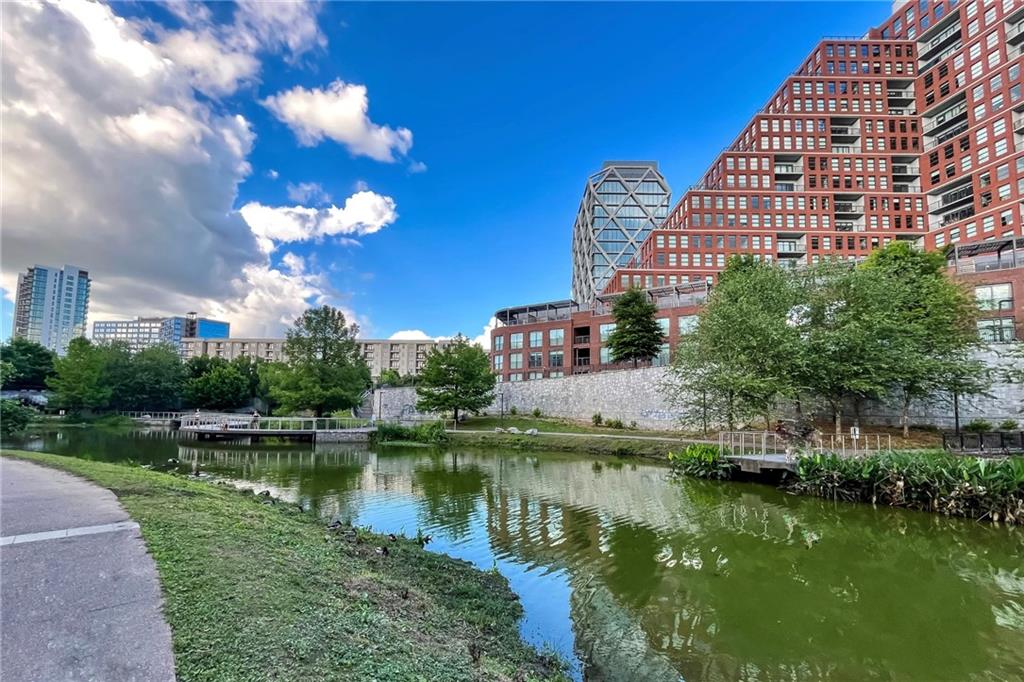 567 Ponce De Leon Avenue Northeast, Unit 321 Atlanta, GA 30308 - Photo 27 of 28 a view of a lake with a building in the background