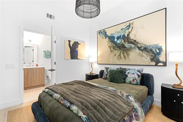 a bedroom with a bed and a painting on the wall