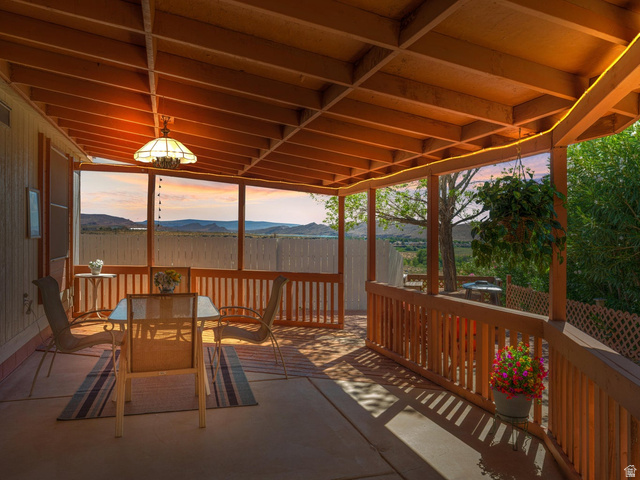 3941 West 40 North Hurricane, UT 84737 - Photo 40 of 55 Covered patio featuring a wood-beam ceiling, exposed rafters, and an overhead light fixture