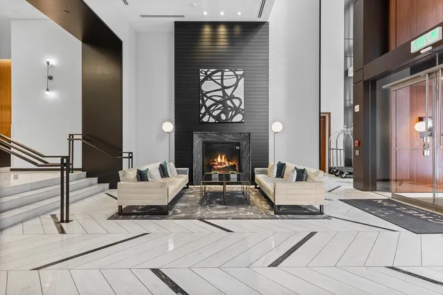 a living room with fireplace furniture and a fireplace