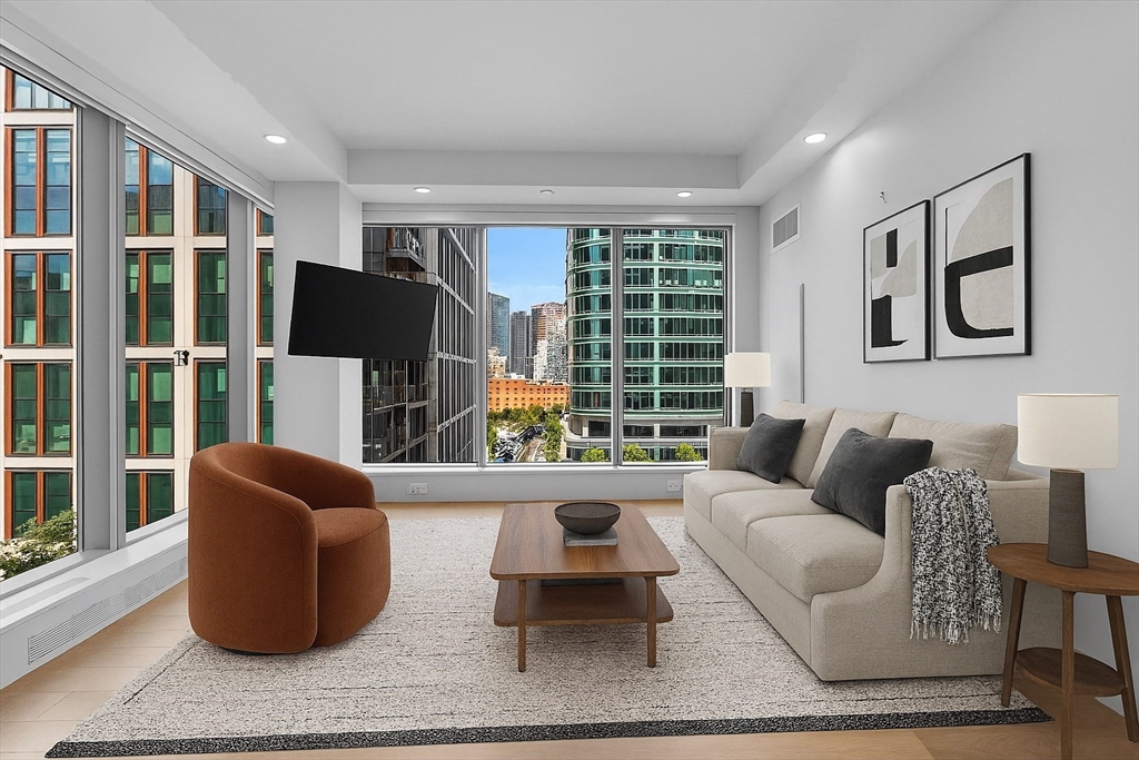 135 Seaport Boulevard, Unit 905 Boston, MA 02210 - Photo 2 of 21 a living room with furniture and a large window