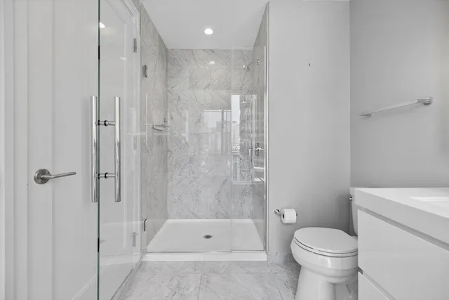 a bathroom with a toilet and a shower