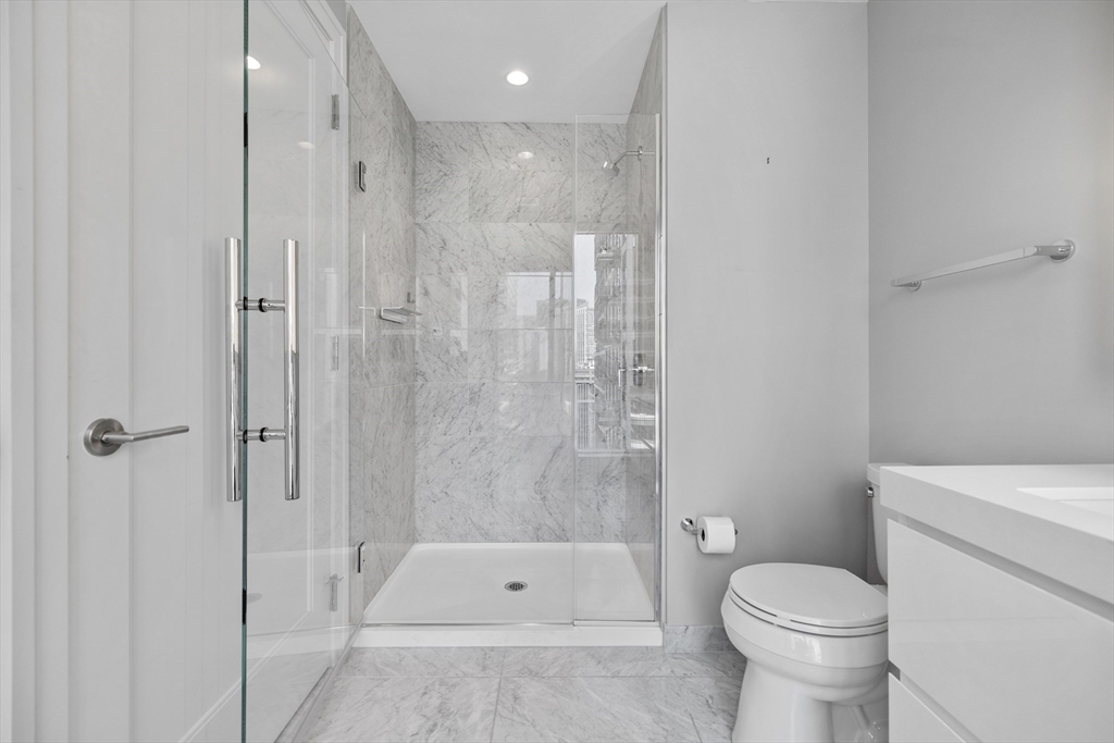 135 Seaport Boulevard, Unit 905 Boston, MA 02210 - Photo 6 of 21 a bathroom with a toilet and a shower