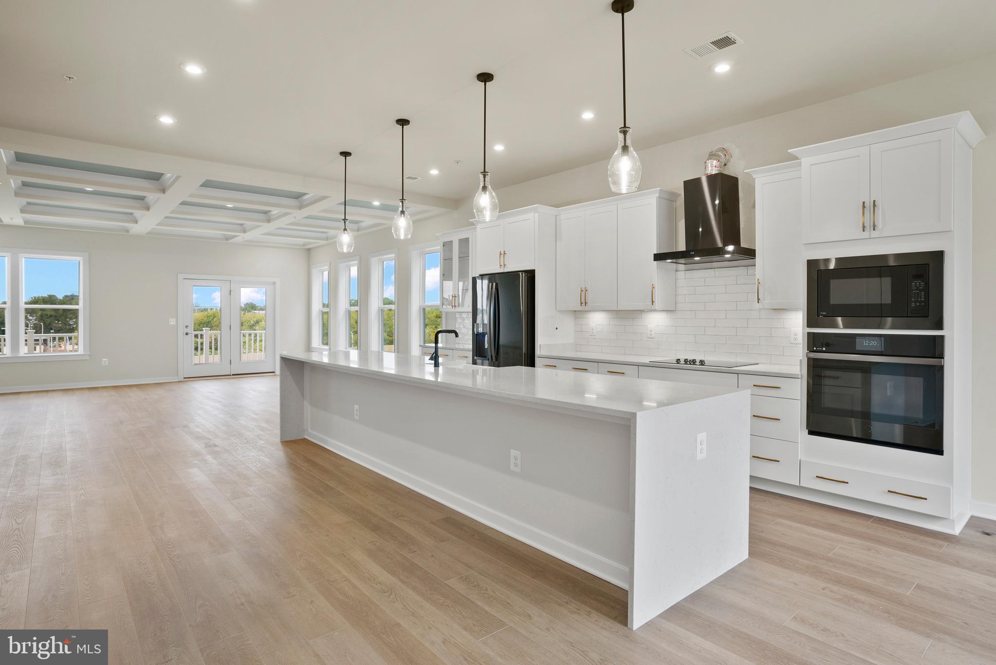 6717 Belcrest Road Hyattsville, MD 20782 - Photo 27 of 29 a kitchen with kitchen island a counter top space appliances and a ceiling fan