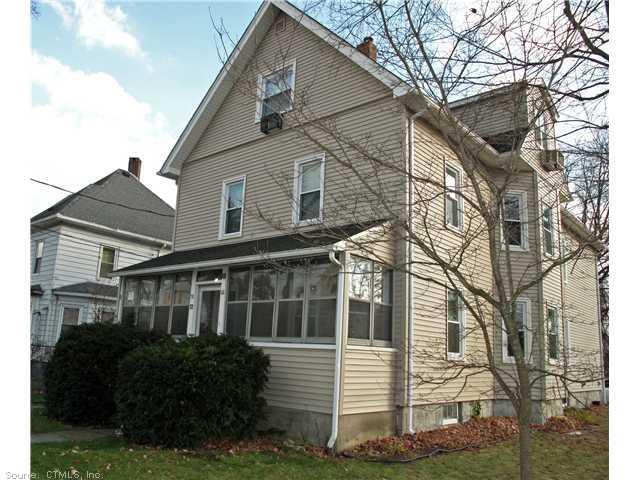 70 Wilson Avenue Windsor, CT 06095 - Photo 1 of 1 a view of a white house next to a yard with big trees