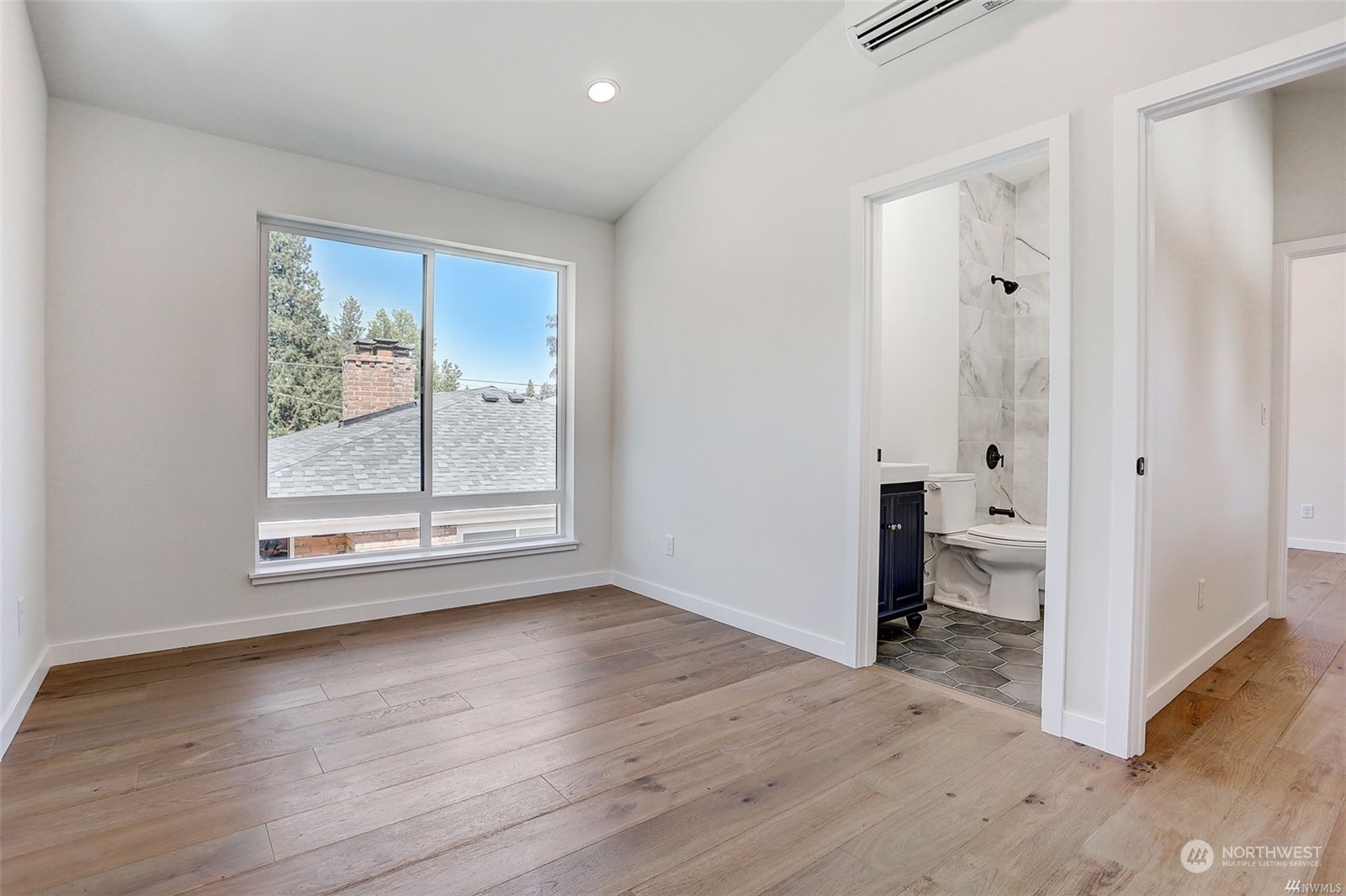 3221 Northeast 86th Street Seattle, WA 98115 - Photo 11 of 22 an empty room with wooden floor and windows