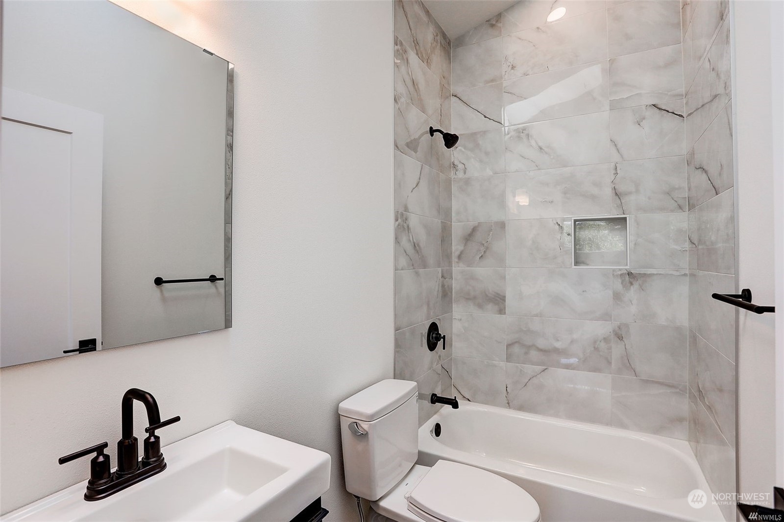 3221 Northeast 86th Street Seattle, WA 98115 - Photo 13 of 22 a bathroom with a sink toilet and shower