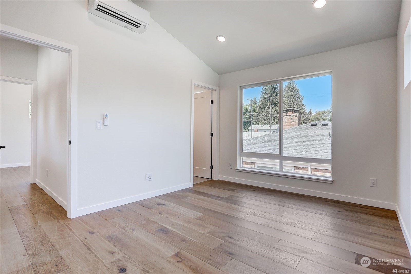 3221 Northeast 86th Street Seattle, WA 98115 - Photo 16 of 22 an empty room with wooden floor and windows
