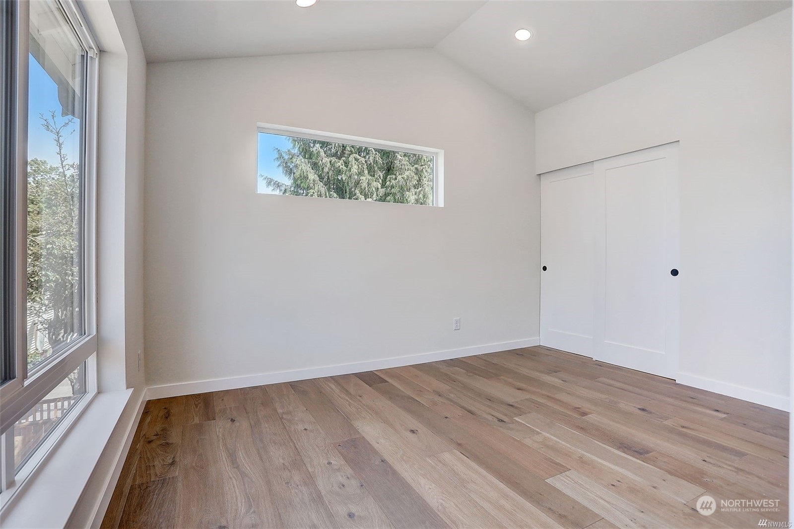 3221 Northeast 86th Street Seattle, WA 98115 - Photo 17 of 22 wooden floor in an empty room with a window