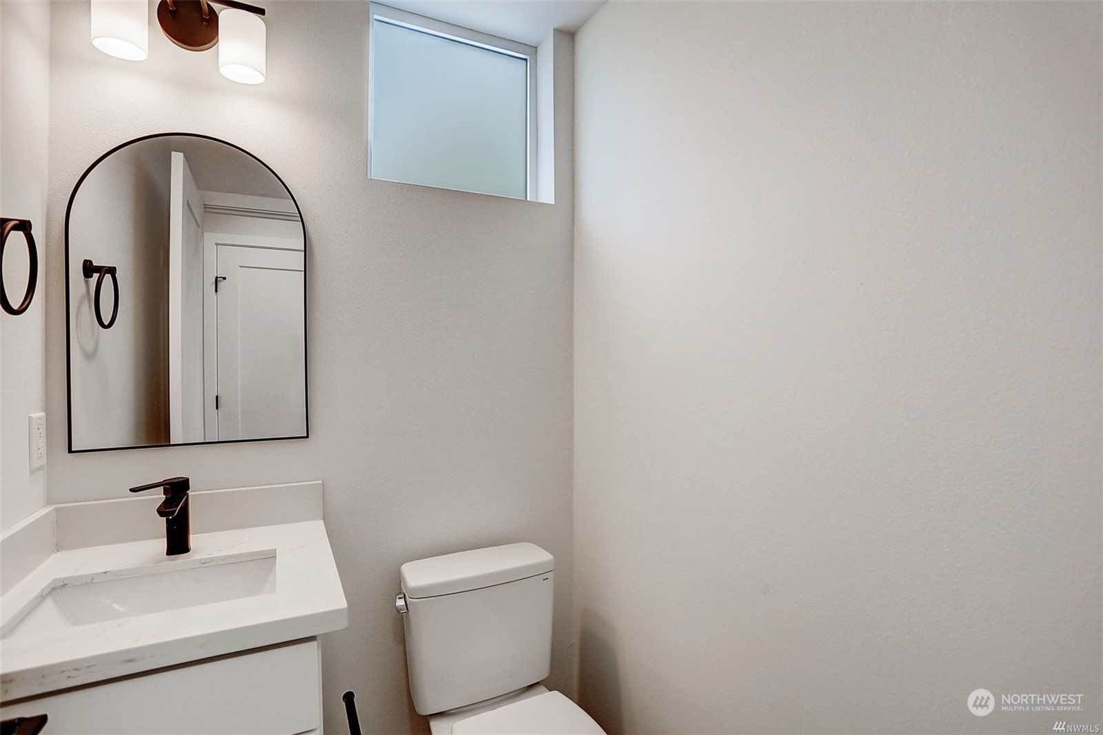3221 Northeast 86th Street Seattle, WA 98115 - Photo 18 of 22 a bathroom with a toilet sink and mirror
