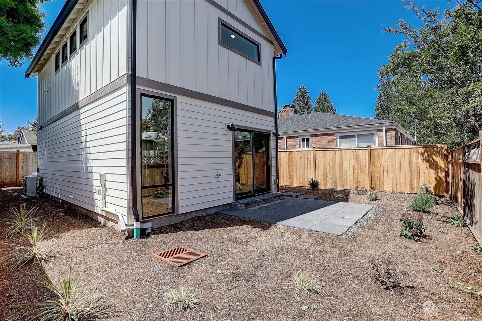 3221 Northeast 86th Street Seattle, WA 98115 - Photo 19 of 22 a backyard of a house with yard and garage