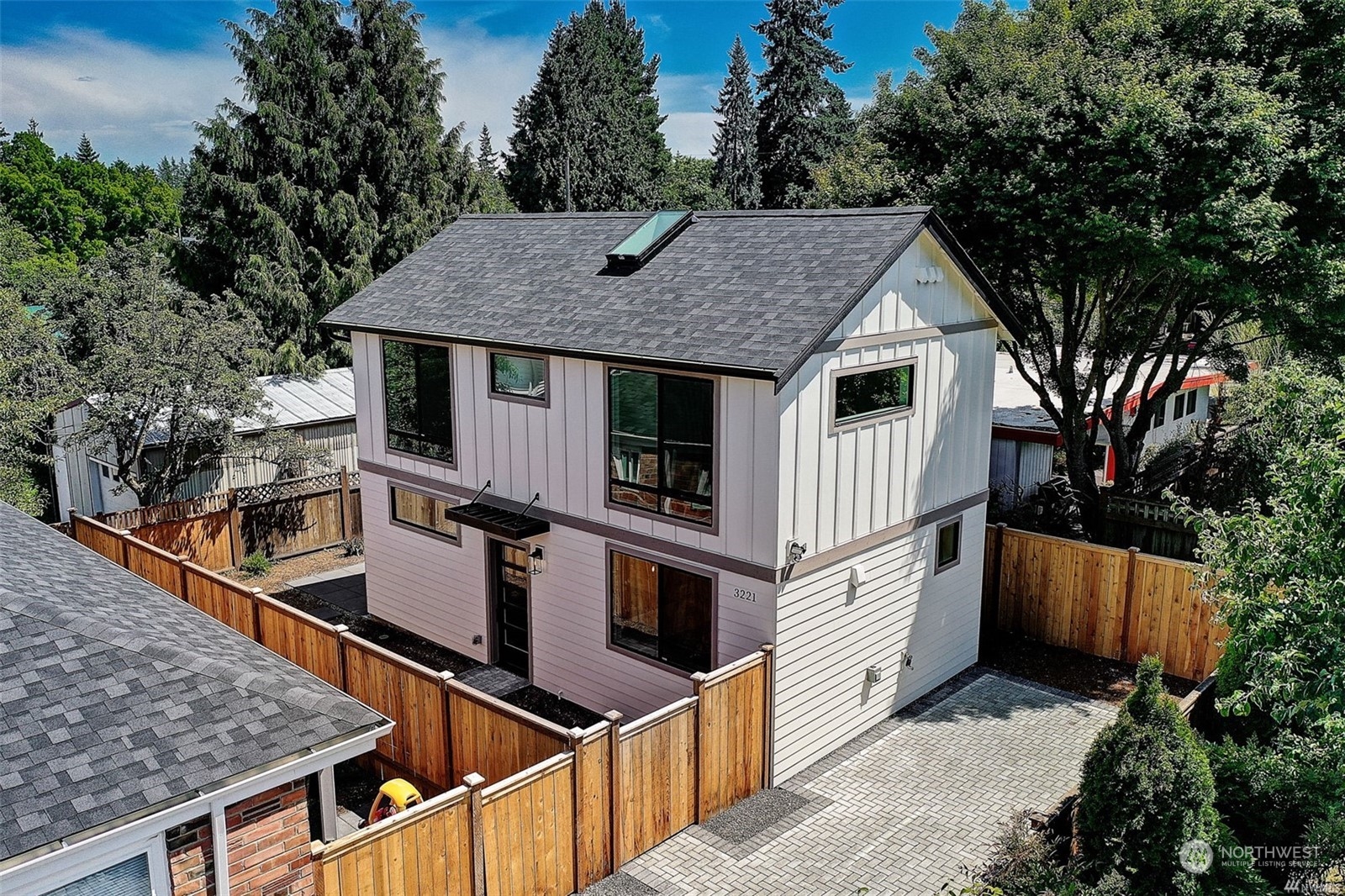 3221 Northeast 86th Street Seattle, WA 98115 - Photo 4 of 22 a view of a house with roof and wooden fence