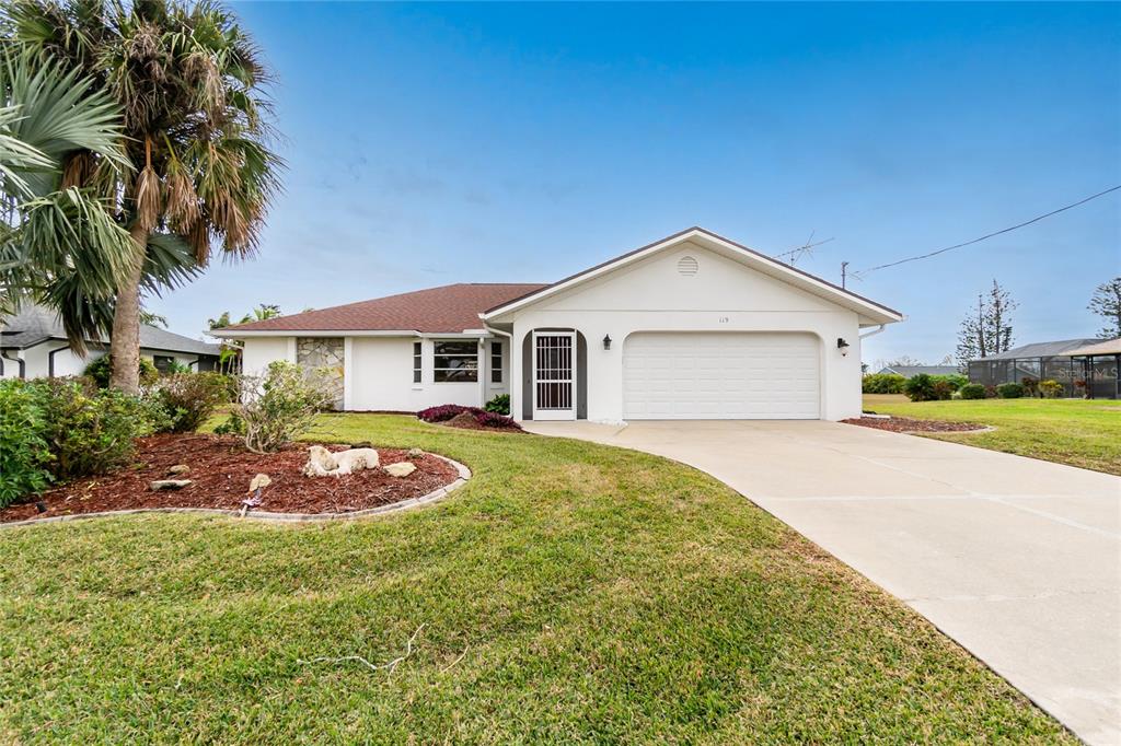 a front view of a house with a yard and garage