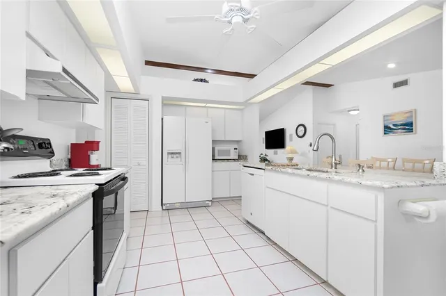 a kitchen with stainless steel appliances granite countertop a sink and cabinets