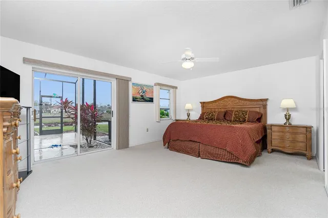 a bedroom with a large bed and a chandelier
