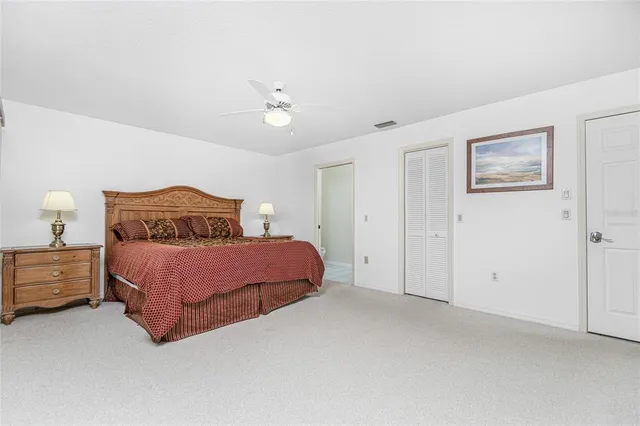 a bedroom with a bed and lamp