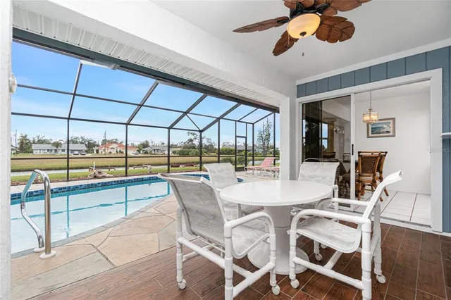 a dining room with furniture and a floor to ceiling window