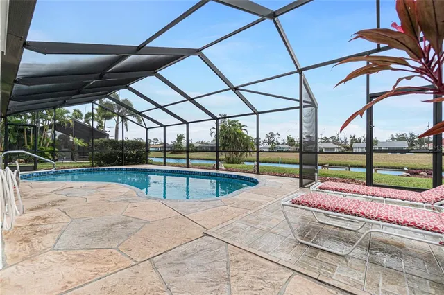 a view of swimming pool with sitting area