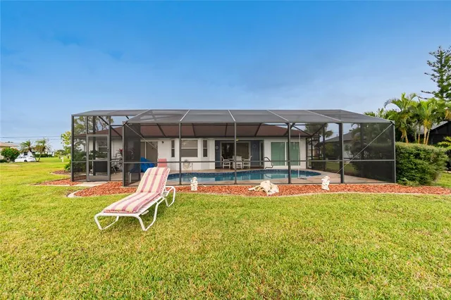 a view of a house with swimming pool and porch with furniture