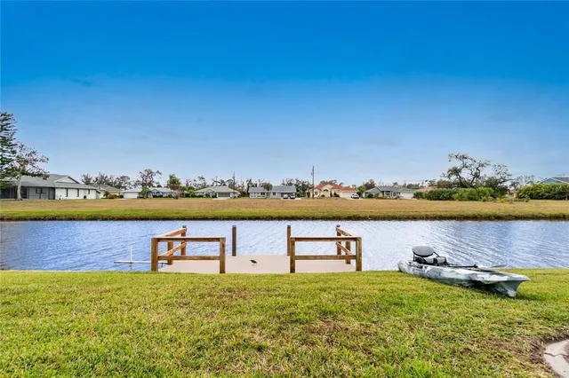 a view of a lake with houses in the back