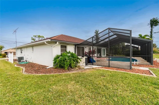a view of a house with a yard and sitting area