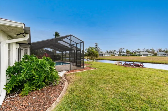 a view of a house with a yard and a garden
