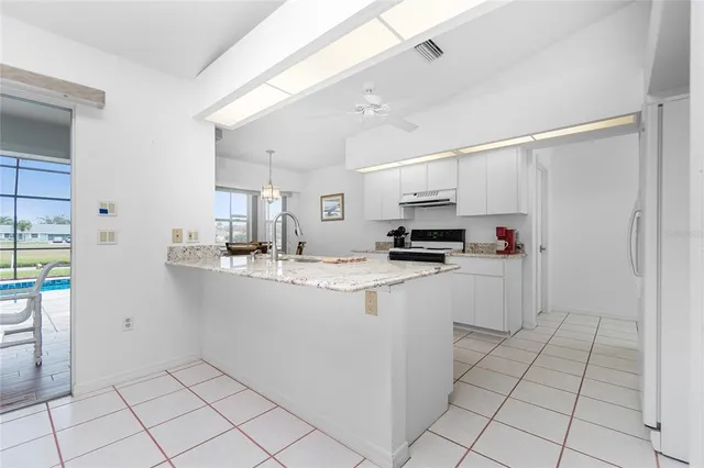 a kitchen with a sink a stove and cabinets