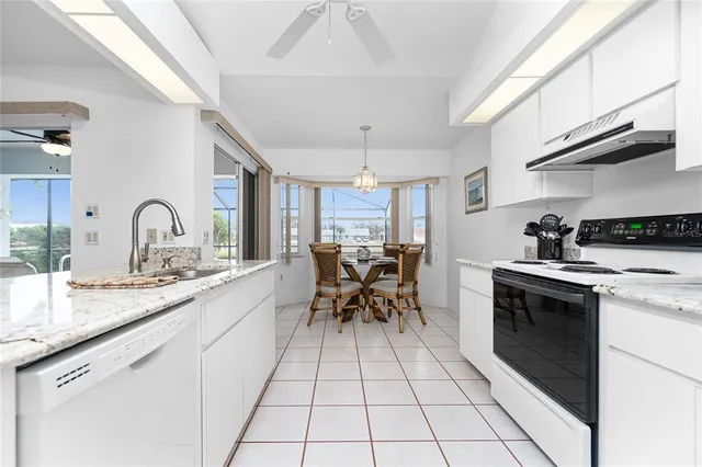 a kitchen with stainless steel appliances a sink stove and cabinets