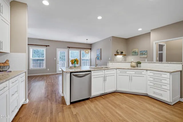 a kitchen with granite countertop a sink and stainless steel appliances
