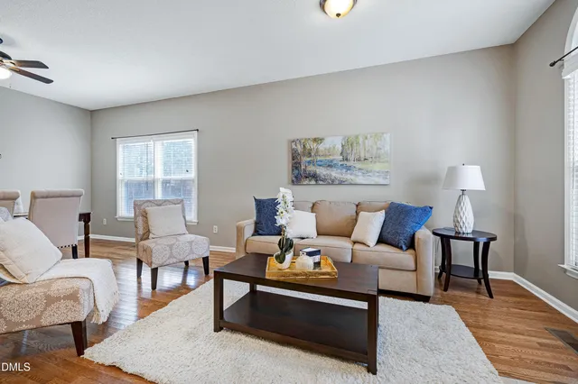 a living room with furniture lamp and rug