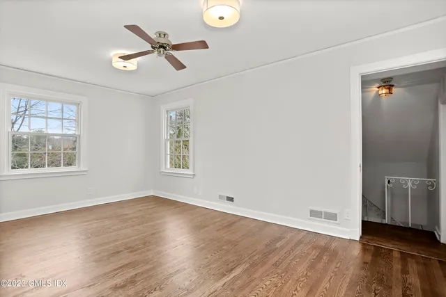 wooden floor in an empty room with a window