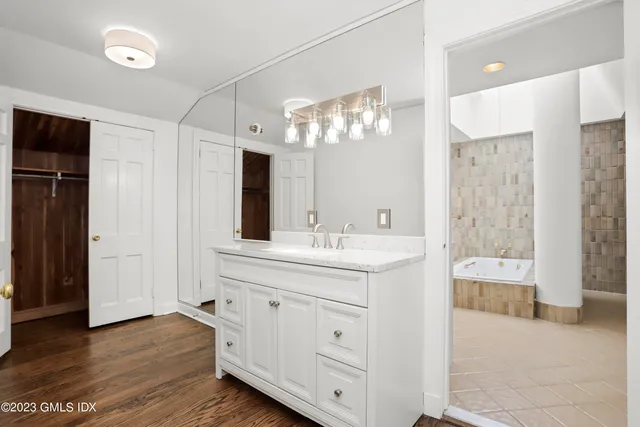 a spacious bathroom with a double vanity sink and a mirror