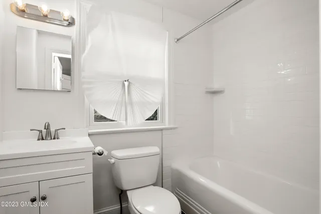 a bathroom with a toilet a sink and bathtub