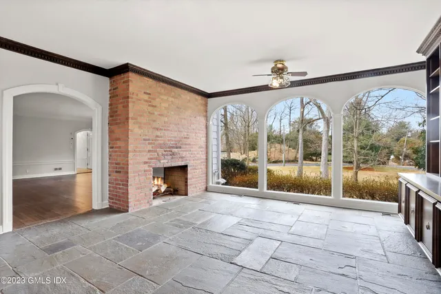 a view of an empty room with a fireplace and a large window