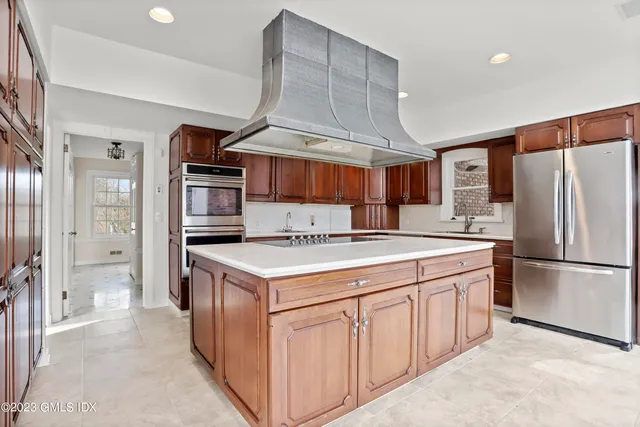 a kitchen that has a stove a refrigerator and a sink