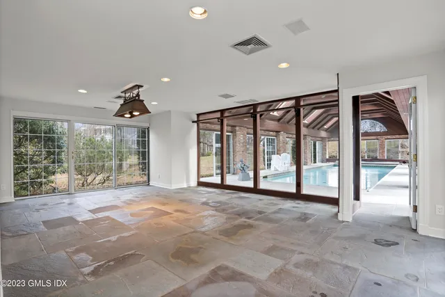 a big room with wooden floor and windows