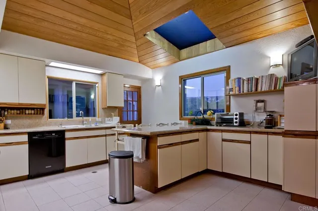 a kitchen with lots of counter space a sink and cabinets