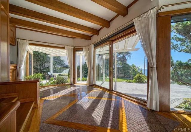 a view of a room with wooden floor and furniture