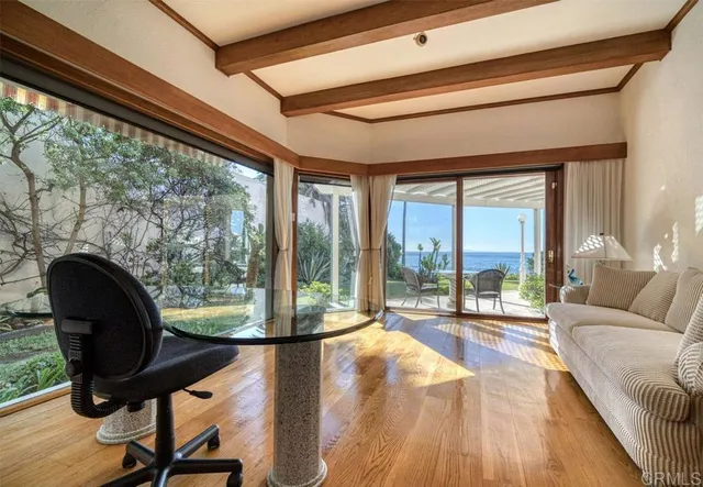 a living room with furniture and a floor to ceiling window