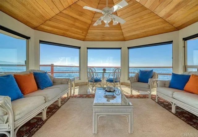 a living room with furniture and a ceiling fan